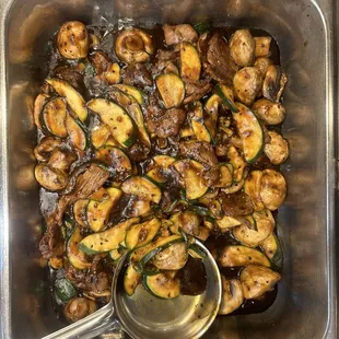 a bowl of mushrooms and zucchini