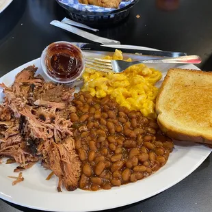 Pulled pork plate with Mac &amp; cheese &amp; baked beans!! The pork was so tender &amp; tasty. You didn&apos;t even need the BBQ sauce.