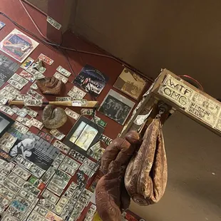 Money wall with very old school boxing gloves and baseball bat with mitts