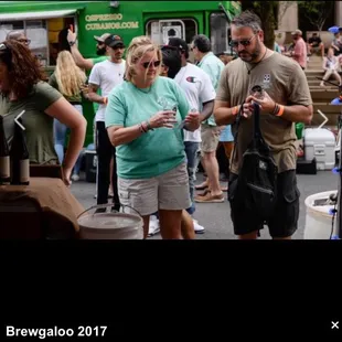 a group of people standing around a food truck