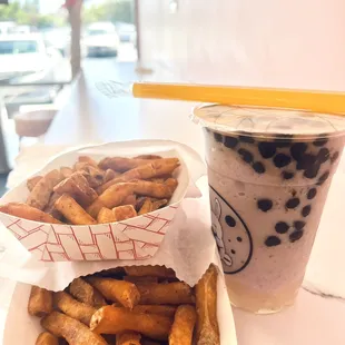 2 orders of seasoned fries and a regular sized coconut taro slush with tiger boba and coconut jelly.