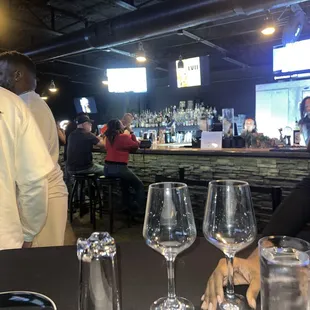 a man and a woman sitting at a bar