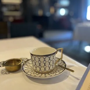 a cup and saucer on a table