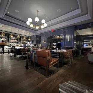 a restaurant with a bar and chairs