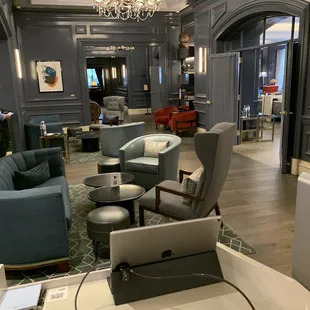 a living room with couches, chairs, and a bathtub