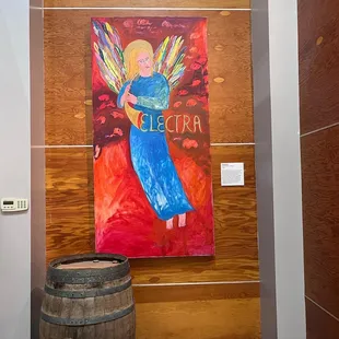 a painting of an angel holding a wine barrel