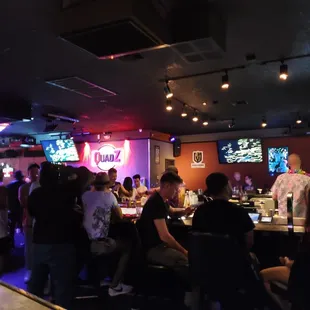 a large group of people sitting at a bar