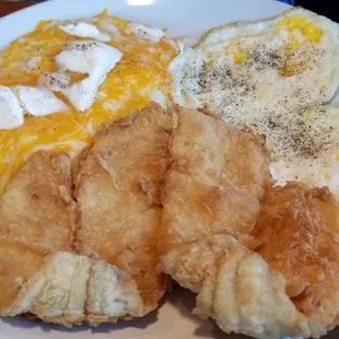 Fried Flounder cheddar cheese grits and fried eggs and wheat toast