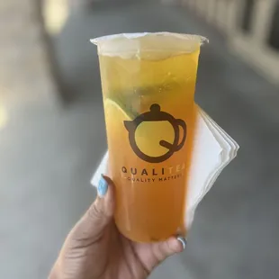 a hand holding a cup of tea
