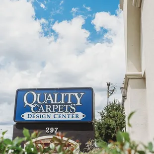 a sign for quality carpets design center