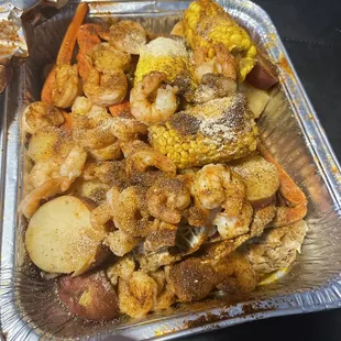 a tray of seafood and potatoes