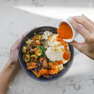 a person holding a bowl of food