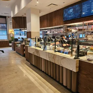 a restaurant counter with a variety of food items