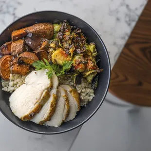a bowl of rice with meat and vegetables