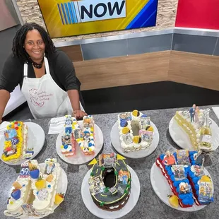 a woman with a variety of cakes