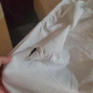 Torn fitted sheet, just one of the holes