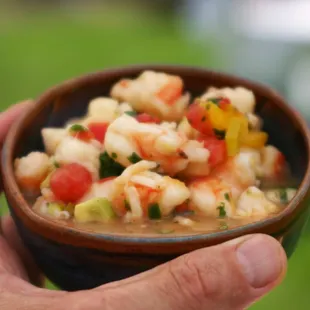a person holding a bowl of food
