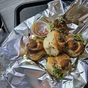 a plate of sausages wrapped in foil