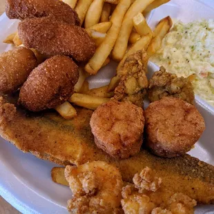 Lunch Sampler: Trout, 2 Shrimp, 2 Scallops, 2 Oysters.  Hush puppies, Fries, Slaw.  $7.80