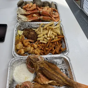 three trays of food on a table