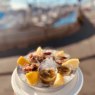 a person holding a plate of seafood