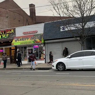a white car parked in front of the restaurant