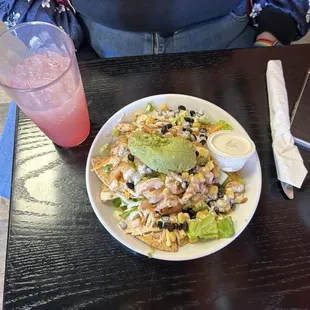 Loaded nachos with shrimp and guacamole and a sunset lemonade.