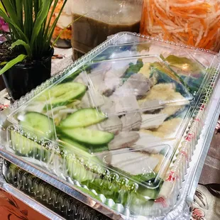 a plastic container filled with sliced cucumbers