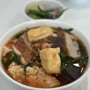 a bowl of soup with meat and vegetables