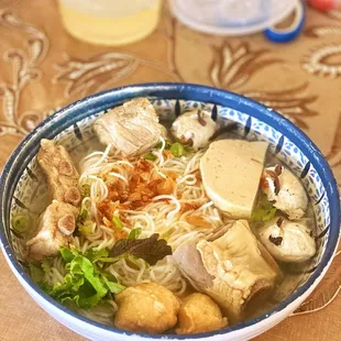 a blue and white bowl of food