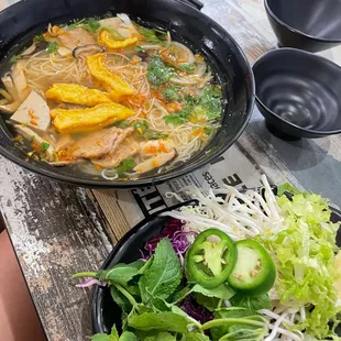 a bowl of soup and a plate of salad