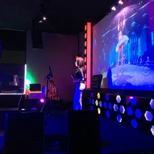 a man standing in front of a projection screen