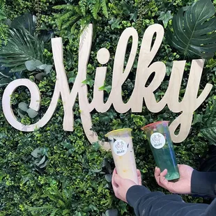 a person holding a cup of milk