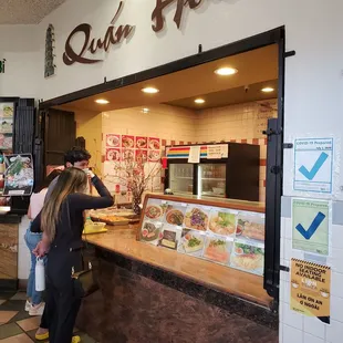 customers ordering food at counter