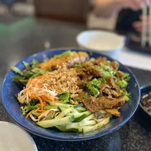 Vermicelli bowl with grilled lemongrass pork and eggrolls
