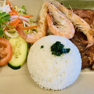 BBQ pork chop, grilled shrimp with rice and a side salad