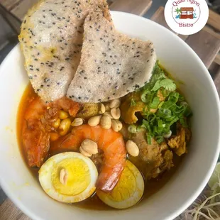 a bowl of soup with bread and vegetables
