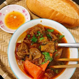 a bowl of stew and a loaf of bread