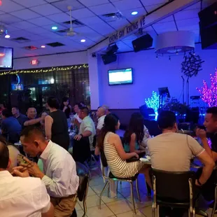 people sitting at tables in a restaurant