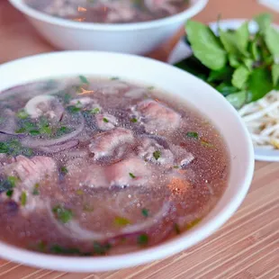 a bowl of soup and a plate of noodles