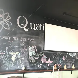 Big chalkboard and a projection screen for one TV.