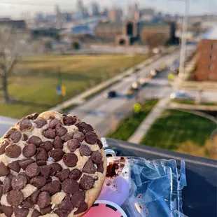 a hand holding a chocolate chip cookie