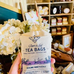 a hand holding a bag of tea bags
