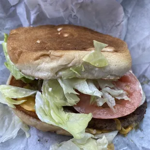 photo of the burger they served me. patty hanging of the bun, lettuce everywhere. This is how they treat their customers.