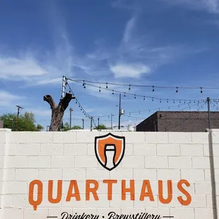 the quarthaus logo on a brick wall