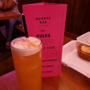 a glass of beer and a pretzel