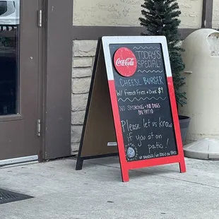 a chalkboard sign on the sidewalk