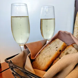 Two champagne glasses and warm focaccia bread