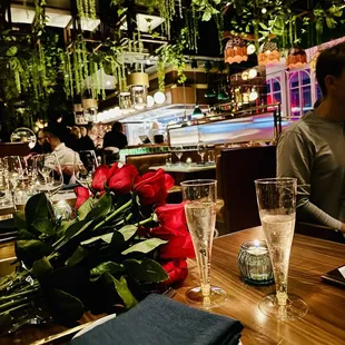 a table with roses and wine glasses