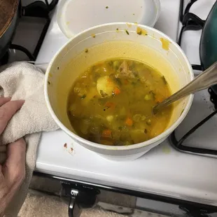 Unknown soup with peas, carrots, potatoes, herbs, and a little bit or chicken.